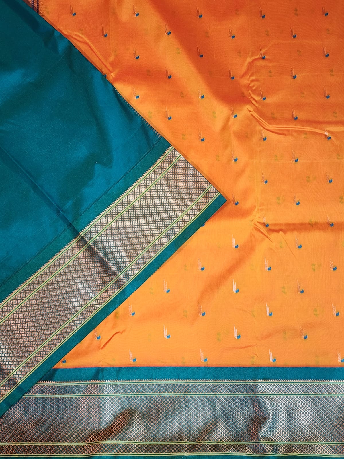 Mustard yellow Paithani saree with Teal Blue Kadiyal border and muniya motif