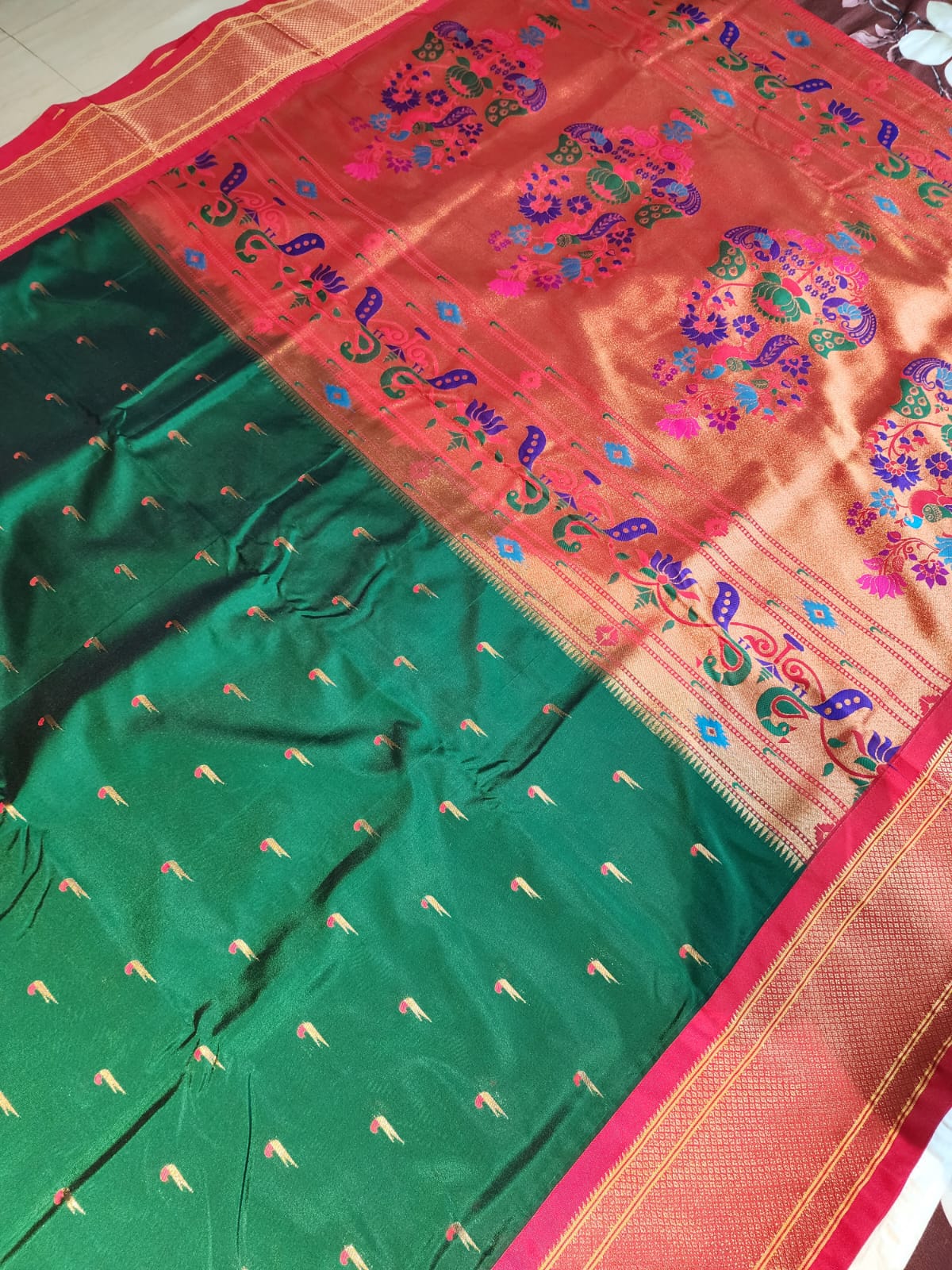 Bottle Green Paithani Saree with red Kadiyal border and muniya motif