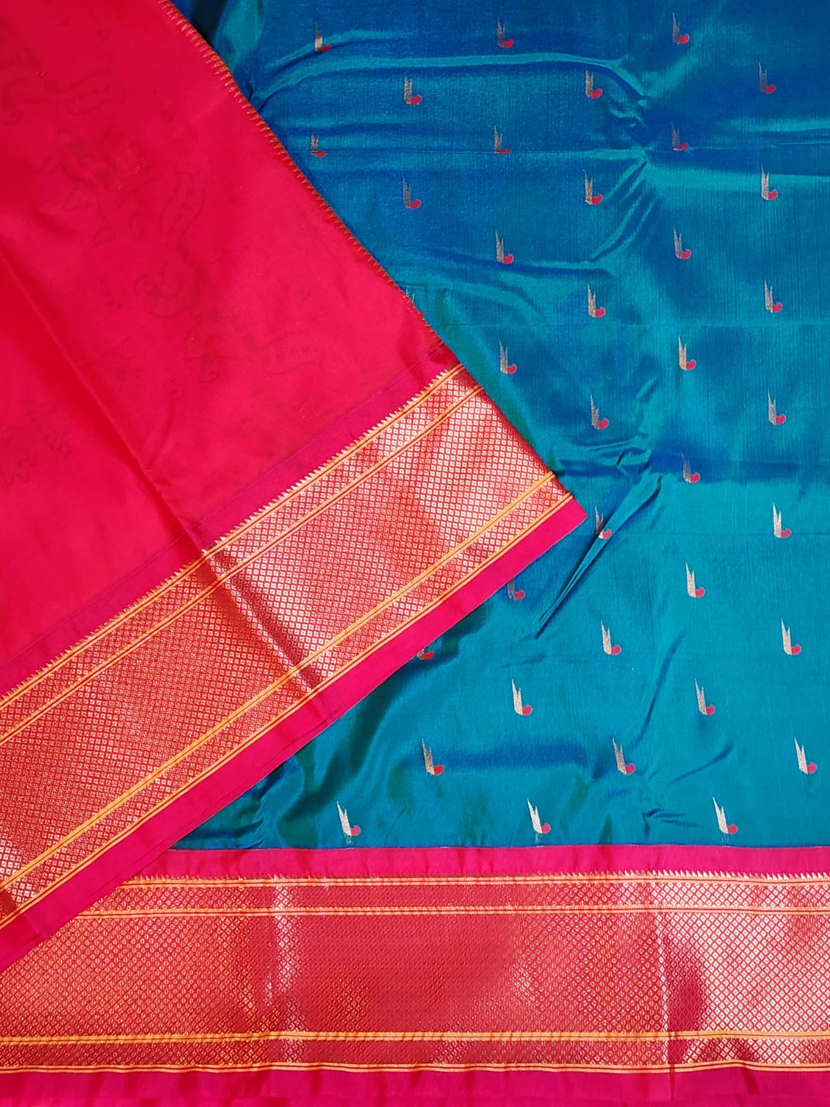 Teal Blue Paithani saree with Rani Pink Kadiyal border and muniya motif