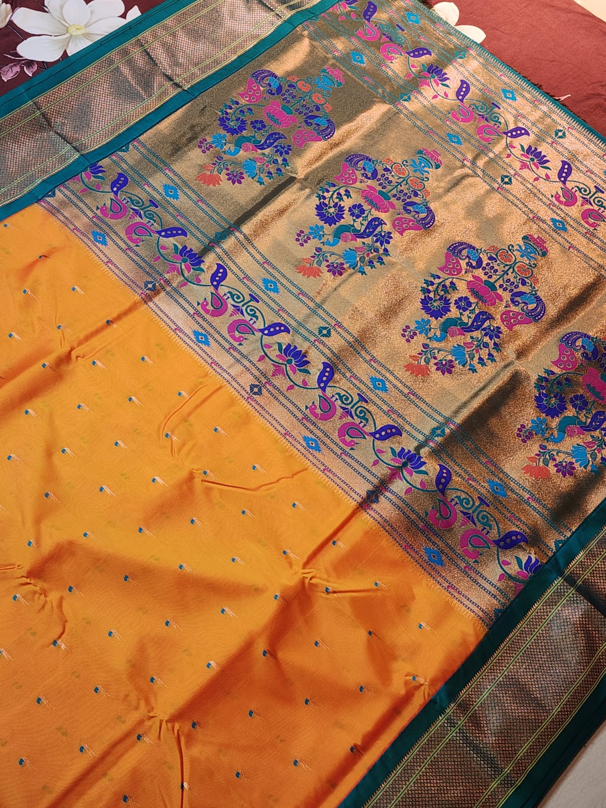 Mustard yellow Paithani saree with Teal Blue Kadiyal border and muniya motif
