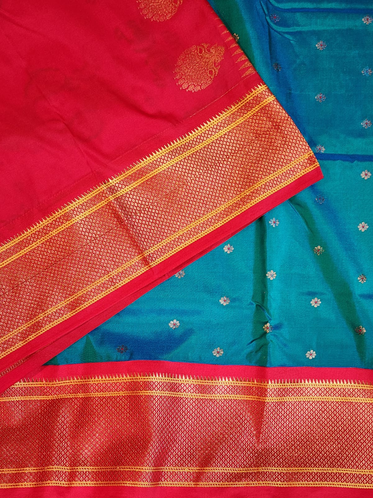 Teal Blue Paithani saree with vibrant red Kadiyal border