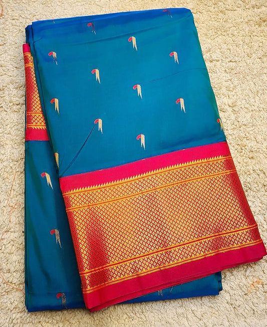 Teal Blue Paithani saree with Rani Pink Kadiyal border and muniya motif