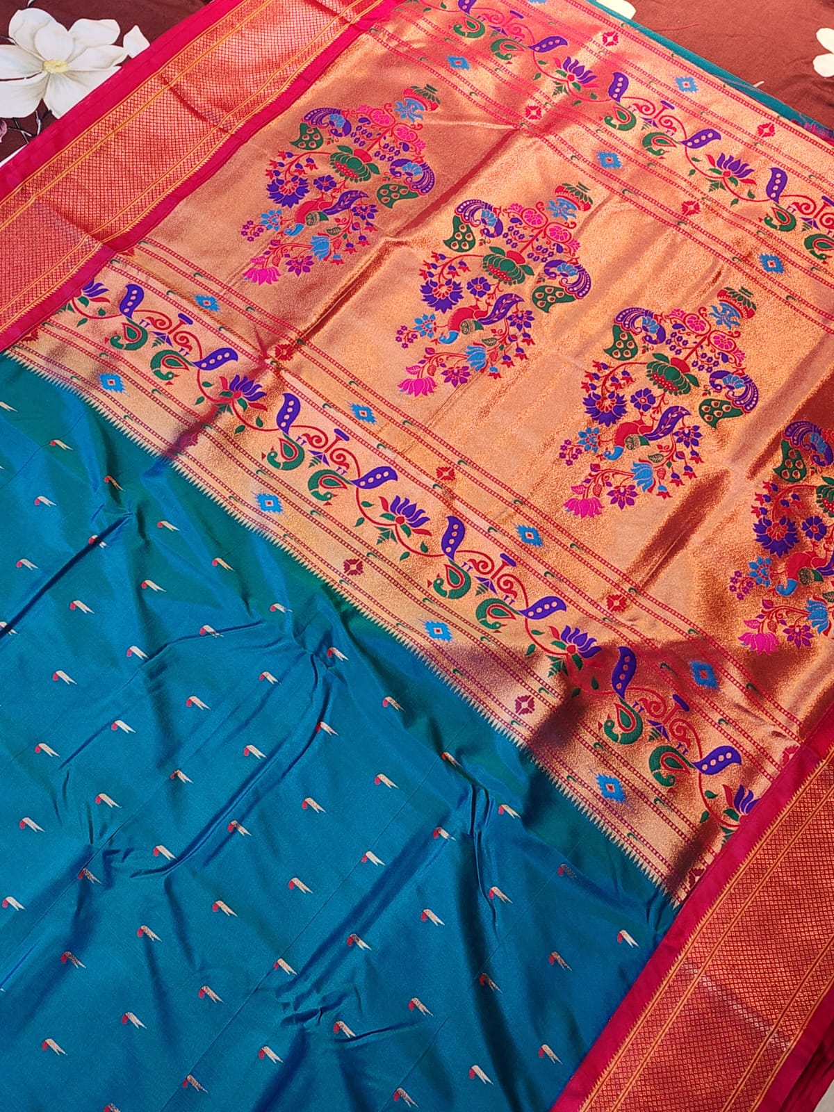 Teal Blue Paithani saree with Rani Pink Kadiyal border and muniya motif